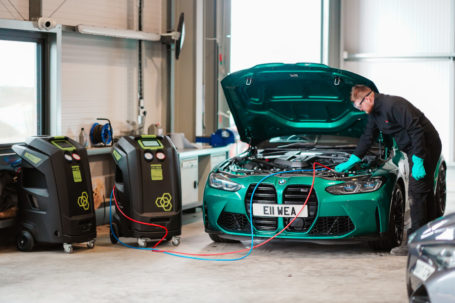 A mechanic performing air conditioning service