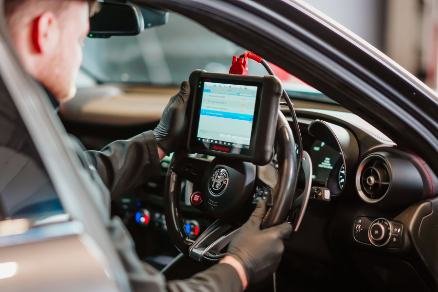 A mechanic performing diagnostic checks on a car