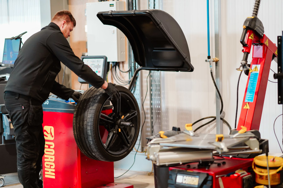 A mechanic servicing a tyre